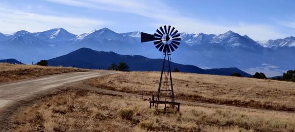 Scenic view of field against mountains against sky