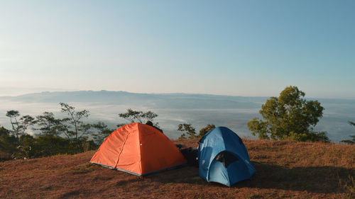 Tents on mountain against sky