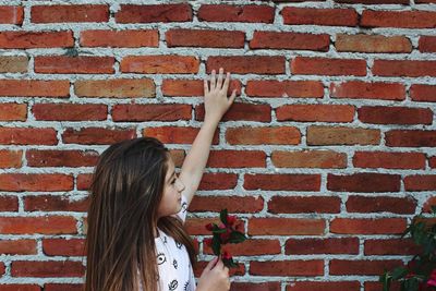 Full length of child against brick wall