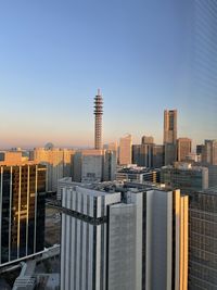 Modern buildings in city against clear sky