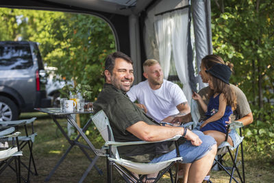 People relaxing at camping site