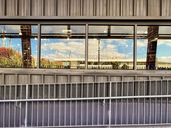 Modern building against sky seen through glass window