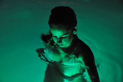 High angle view of young woman swimming in pool