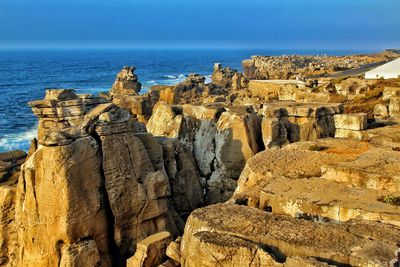 Panoramic view of sea and rocks against sky