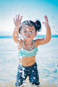 Full length of a girl enjoying in sea