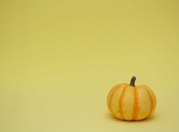 Close-up of pumpkin against yellow background