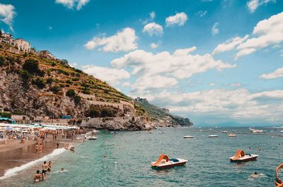 Scenic view of sea and mountains against sky