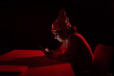 Portrait of young woman using mobile phone at home