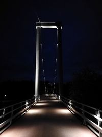 Illuminated bridge against sky at night