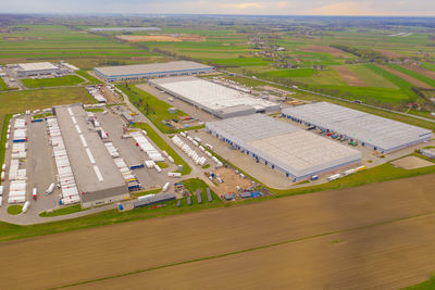 Aerial view of goods warehouse. logistics delivery center in industrial city zone from above. 