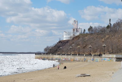 View of beach and buildings against sky