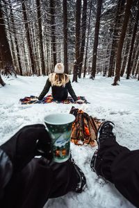 Man and woman on snowcapped field during winter