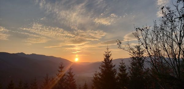 Scenic view of silhouette mountains against sky at sunset