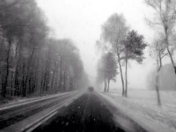 Road passing through snow covered landscape