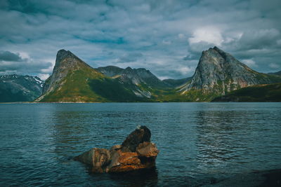 Scenic view of sea and mountains against sky