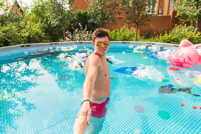 Portrait of shirtless boy in swimming pool