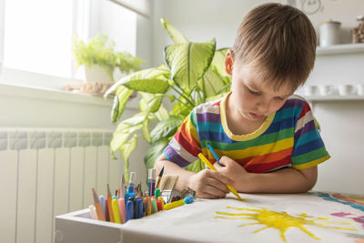 Boy painting at home