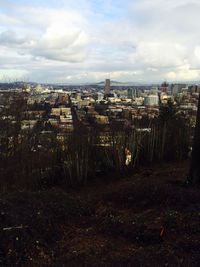 Cityscape against cloudy sky