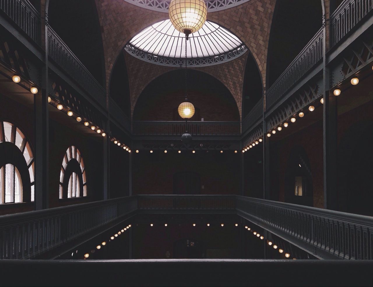 illuminated, indoors, architecture, built structure, night, ceiling, lighting equipment, arch, interior, religion, ornate, chandelier, light - natural phenomenon, no people, architectural feature, corridor, travel destinations, place of worship, pattern