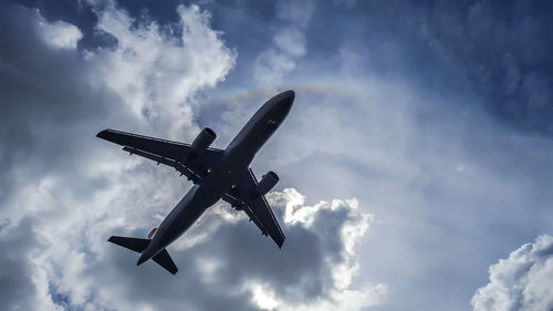 Low angle view of airplane flying in sky