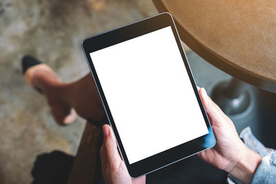 Low angle view of woman using digital tablet