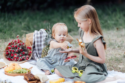 Sibling sitting at park for picnic