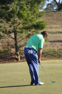 Full length of man standing on golf course