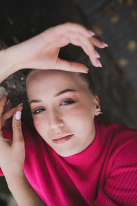 Close-up portrait of woman lying outdoors