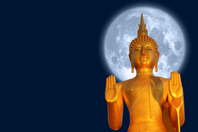 Low angle view of statue against temple against sky