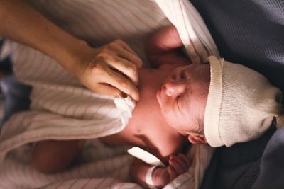 Close-up of a baby girl with hand