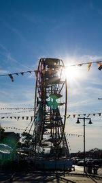 Low angle view of ferris wheel against sky