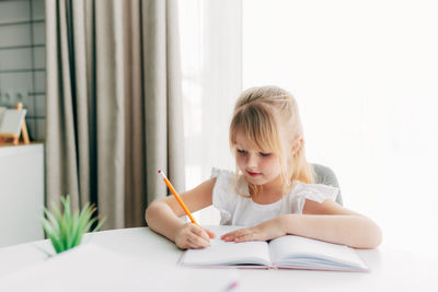 Girl sitting on table