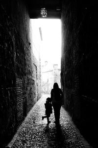 Silhouette man walking in corridor of building