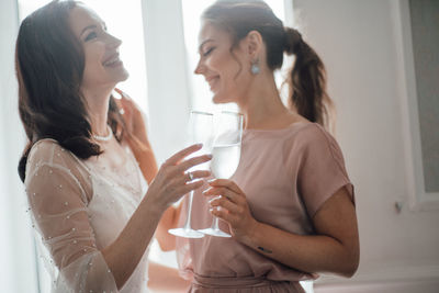 Young woman drinking glasses at home