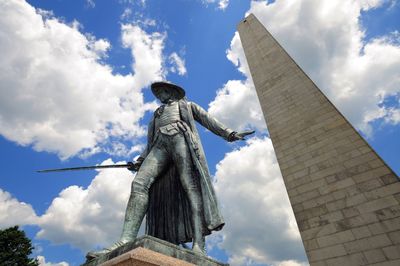 Low angle view of statue against cloudy sky