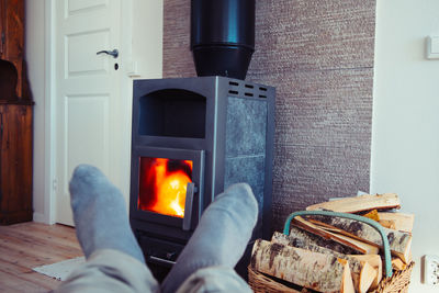 Low section of man against fire at home