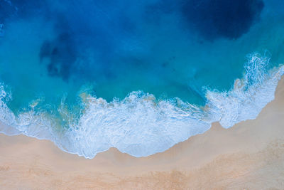 High angle view of waves breaking on beach