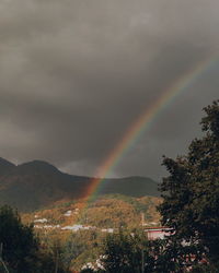 Rainbow over mountain against sky