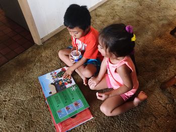 High angle view of siblings playing