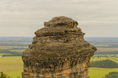 Rock formation against green landscape