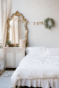 The interior of a bedroom decorated for christmas and new year in a scandinavian or vintage style