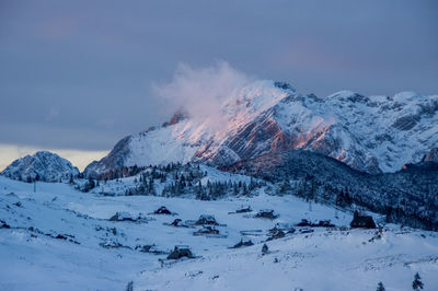 Scenic view of snow covered mountains against sky