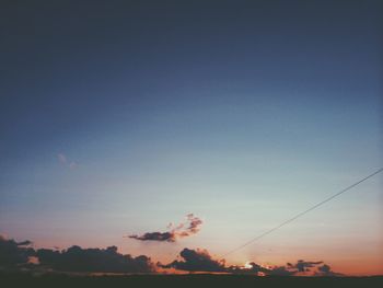 Low angle view of trees against sky at sunset