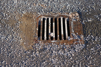 High angle view of metal grate on street