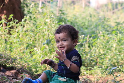 Young boy kid in black t-shirt celebrating happy smiling laughing with finger up on sky