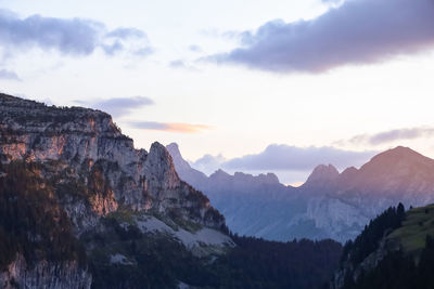 Scenic view of mountains against cloudy sky