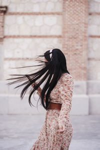 Woman dancing while listening music outdoors