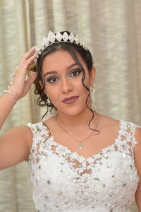 Close-up portrait of beautiful young bride wearing tiara