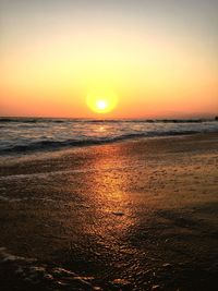 View of calm beach at sunset