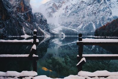 Snowcapped mountains reflecting on calm lake